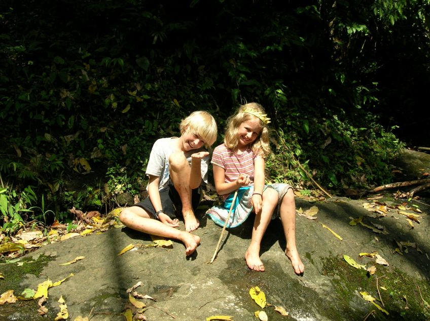 kids on rock near creek